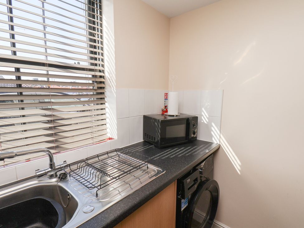 A kitchen with a sink and microwave at Marina Side in Whitby