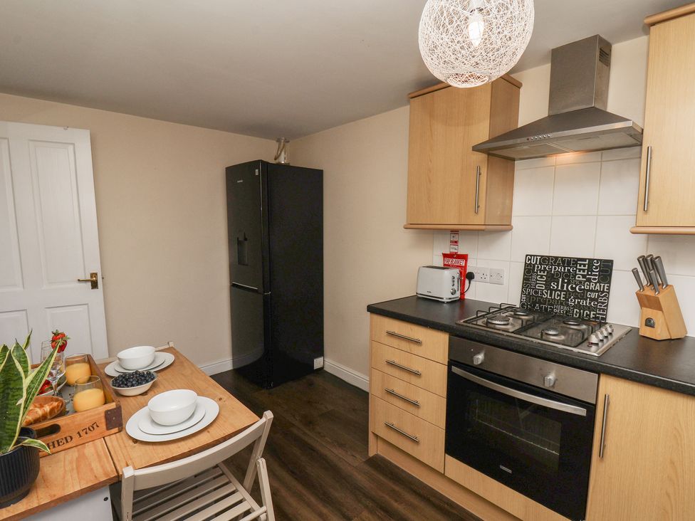 A kitchen with a table and chairs at Marina Side in Whitby
