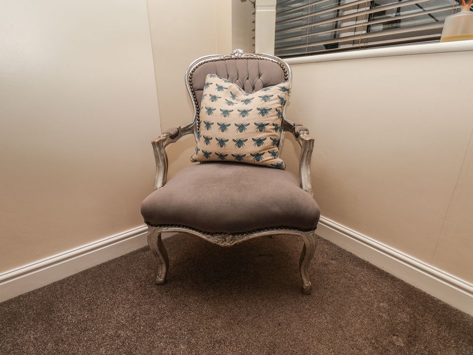 A chair with a cushion in a sitting room at Marina Side in Whitby