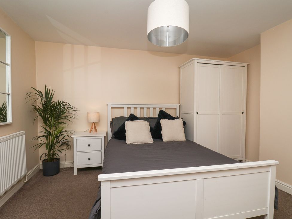 A bedroom with a bed and wardrobe at Marina Side in Whitby