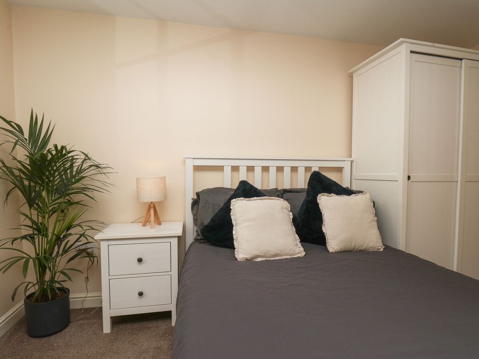 A bedroom with a bed and bedside table at Marina Side in Whitby