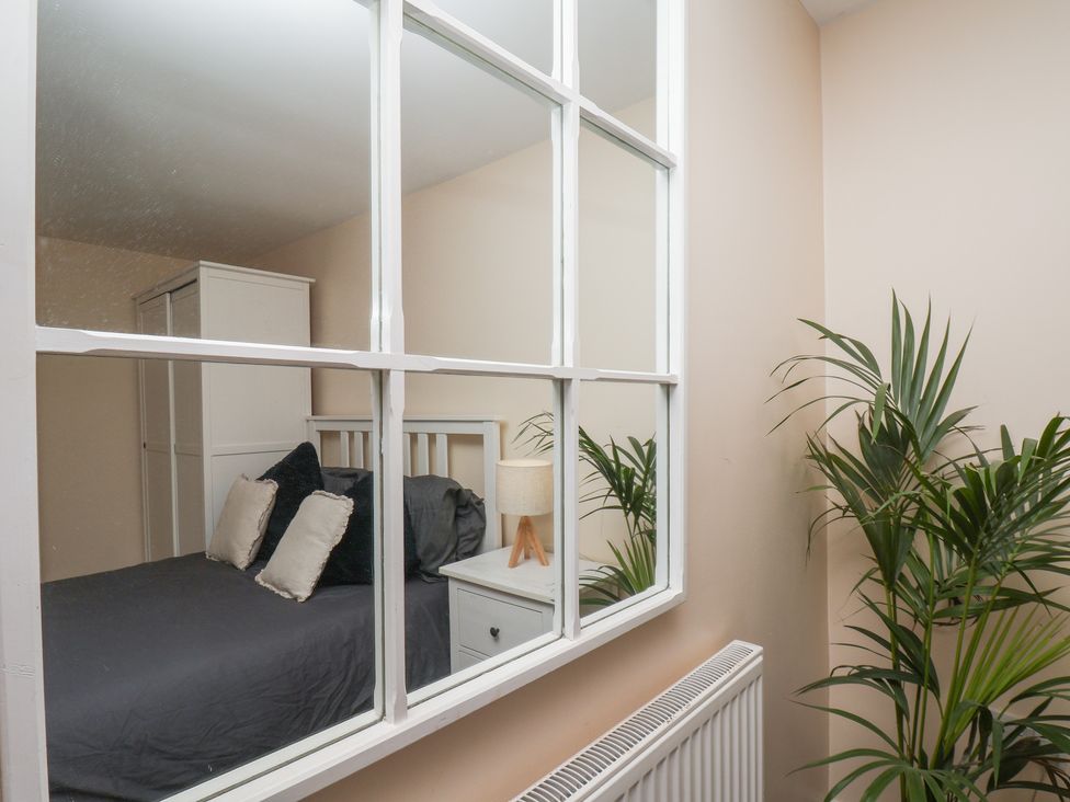 A bedroom with a bed and lamp at Marina Side in Whitby