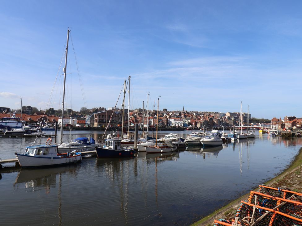 A harbor with boats and buildings at Marina Side in Whitby