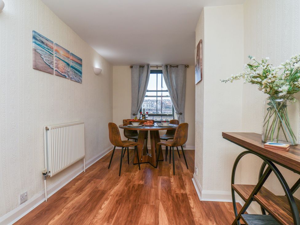 A dining room with a table and chairs at Marina House in Whitby