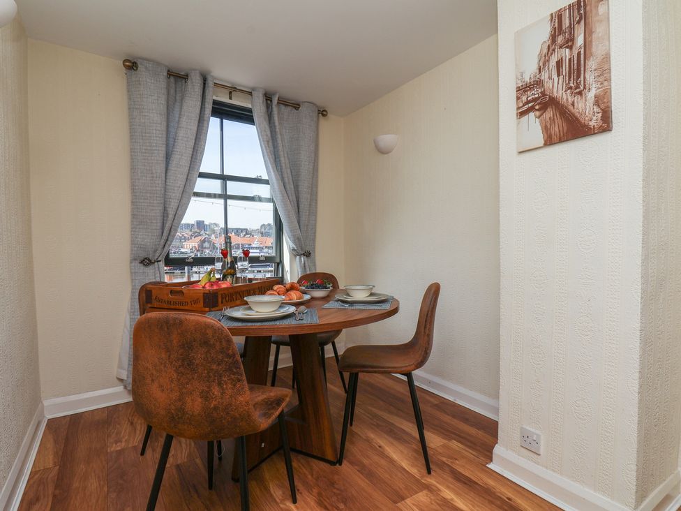 A dining room with a table and chairs at Marina House in Whitby