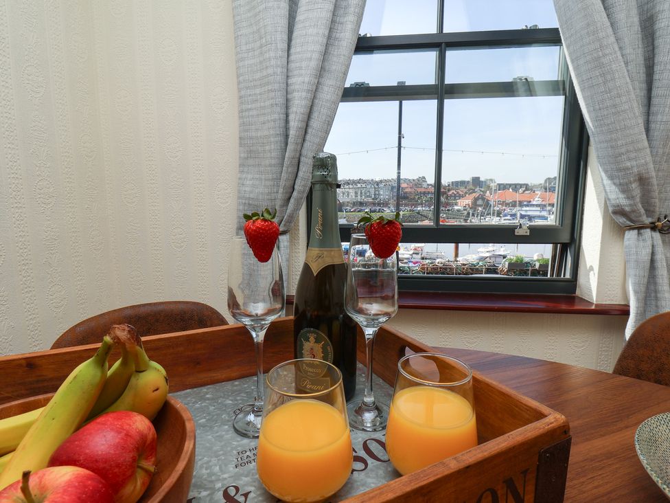 A dining room with drinks and fruits at Marina House in Whitby
