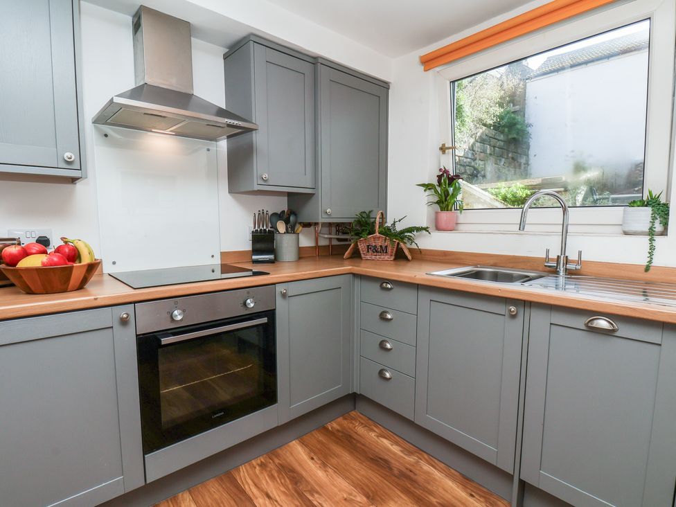 A kitchen with cabinets and appliances at Marina House in Whitby