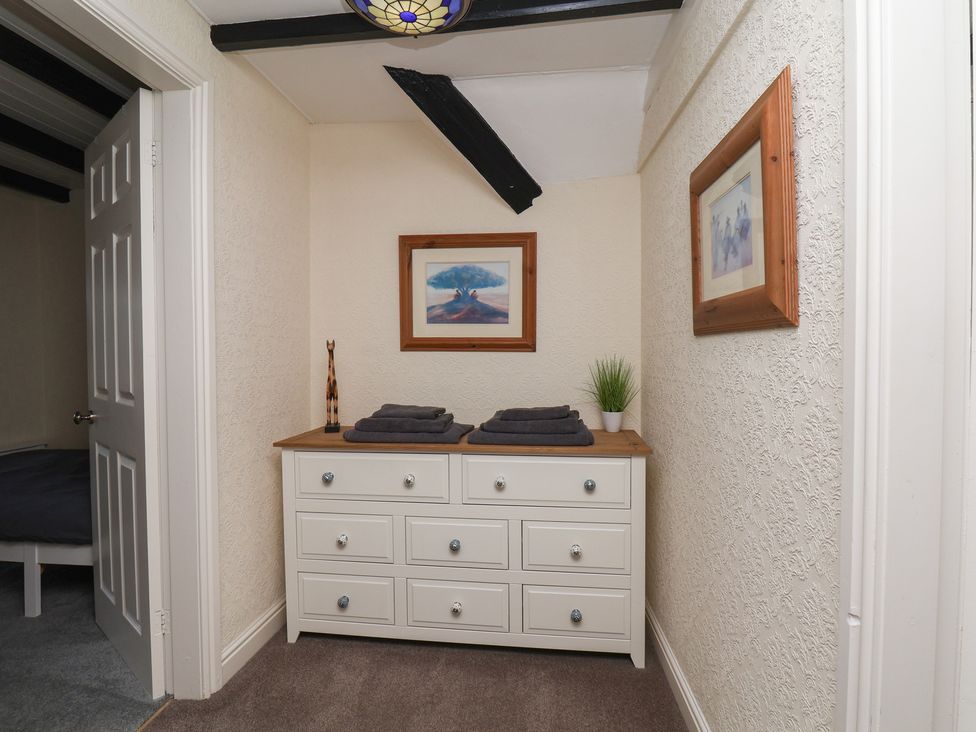 A hallway with a dresser and towels at Marina House in Whitby