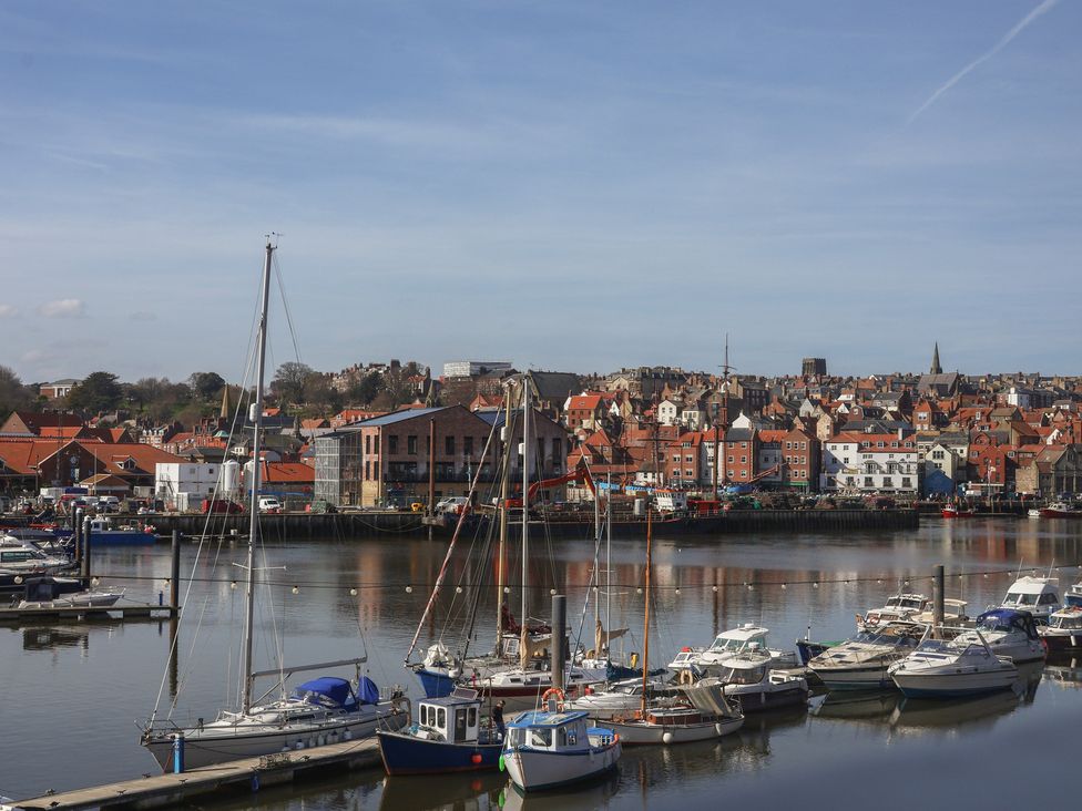 A marina with boats and buildings at Marina House in Whitby