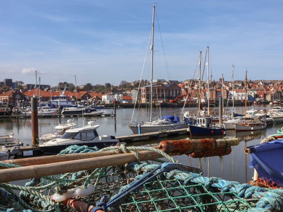 A harbor with boats and buildings at Marina House in Whitby