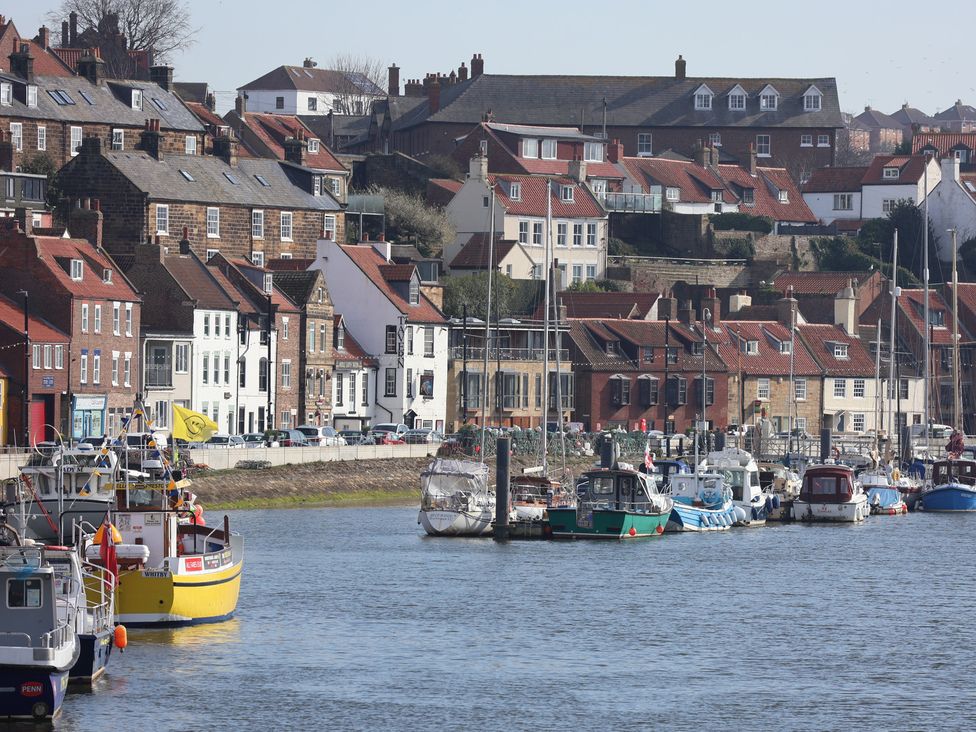 A harbor with boats and buildings at Marina House in Whitby
