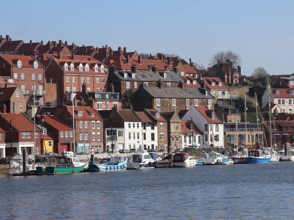 A waterfront view with houses and boats at Marina House in Whitby