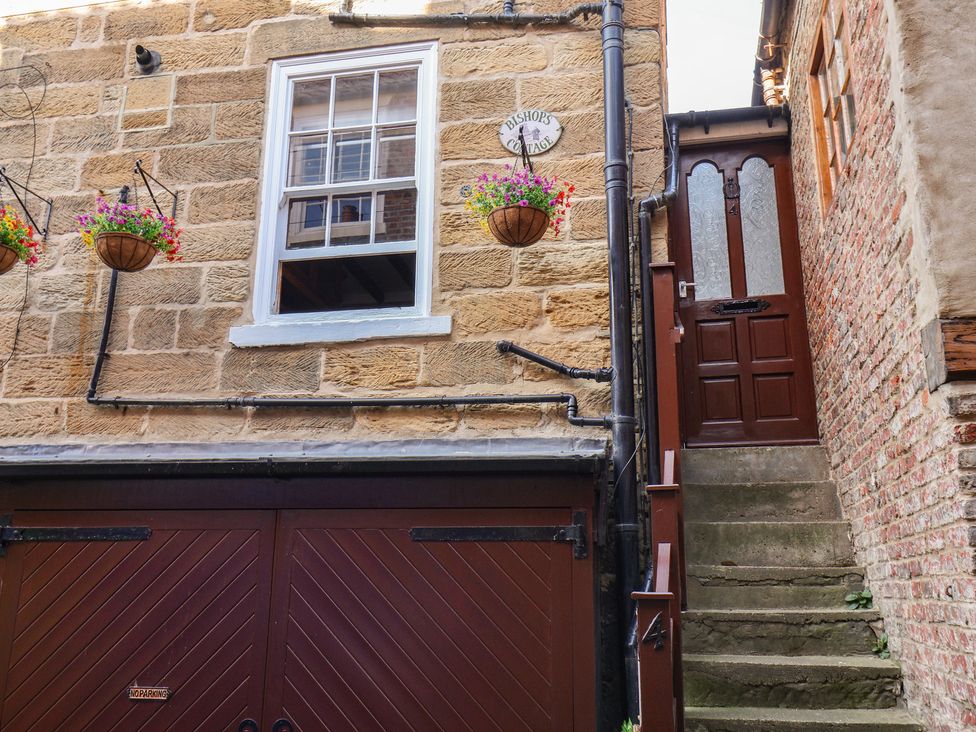 An outdoor view of a property with stairs and flowers at Bishop's Cottage in Whitby