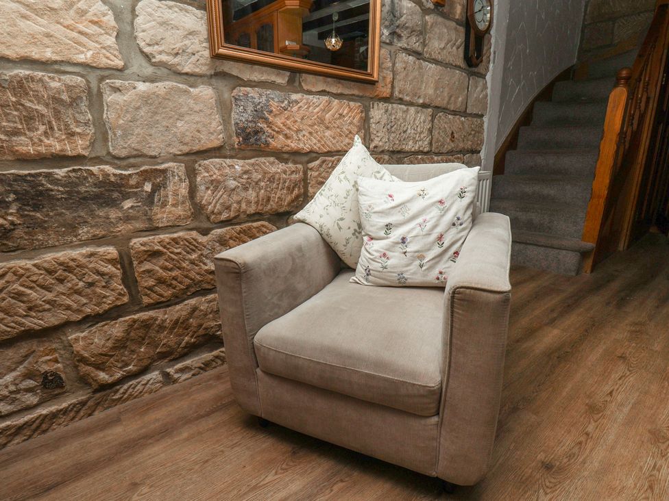 An armchair with cushions in a hallway at Bishop's Cottage in Whitby