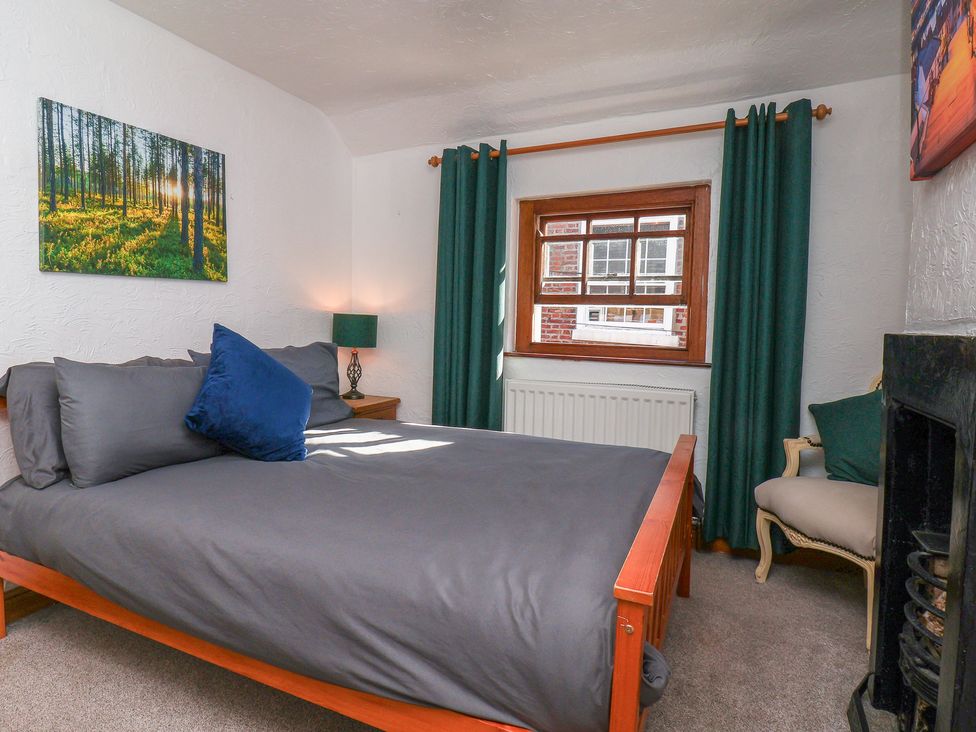 A bedroom with a bed and window at Bishop's Cottage in Whitby