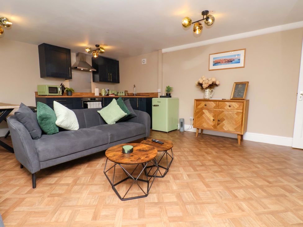 A living room with a sofa and coffee table at G's Loft in Whitby