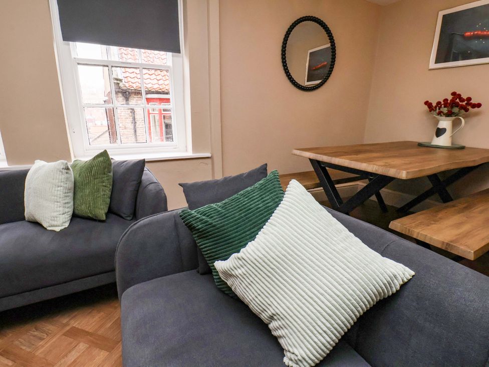 A living room with a sofa and table at G's Loft in Whitby