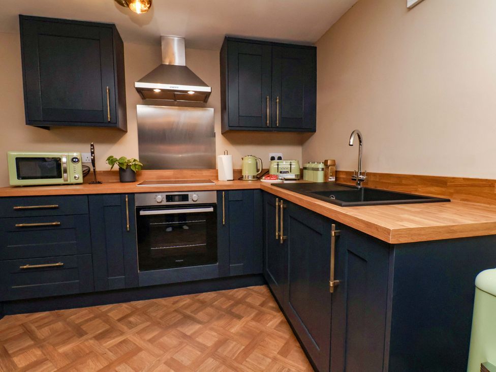 A kitchen with cabinets and countertop at G's Loft in Whitby