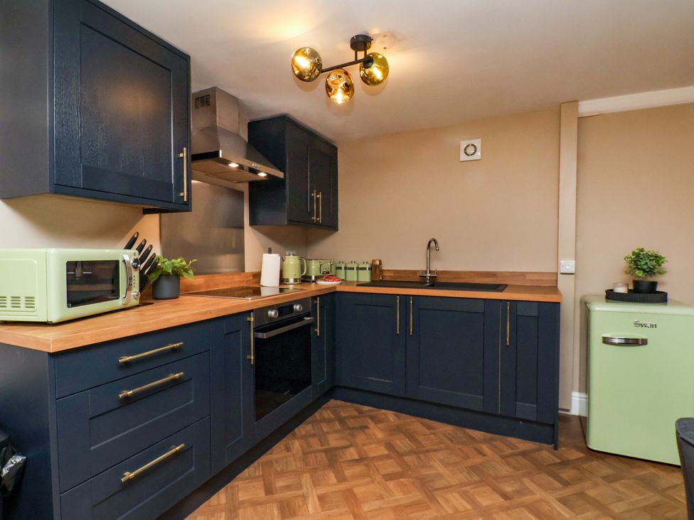 A kitchen with a sink and appliances at G's Loft in Whitby