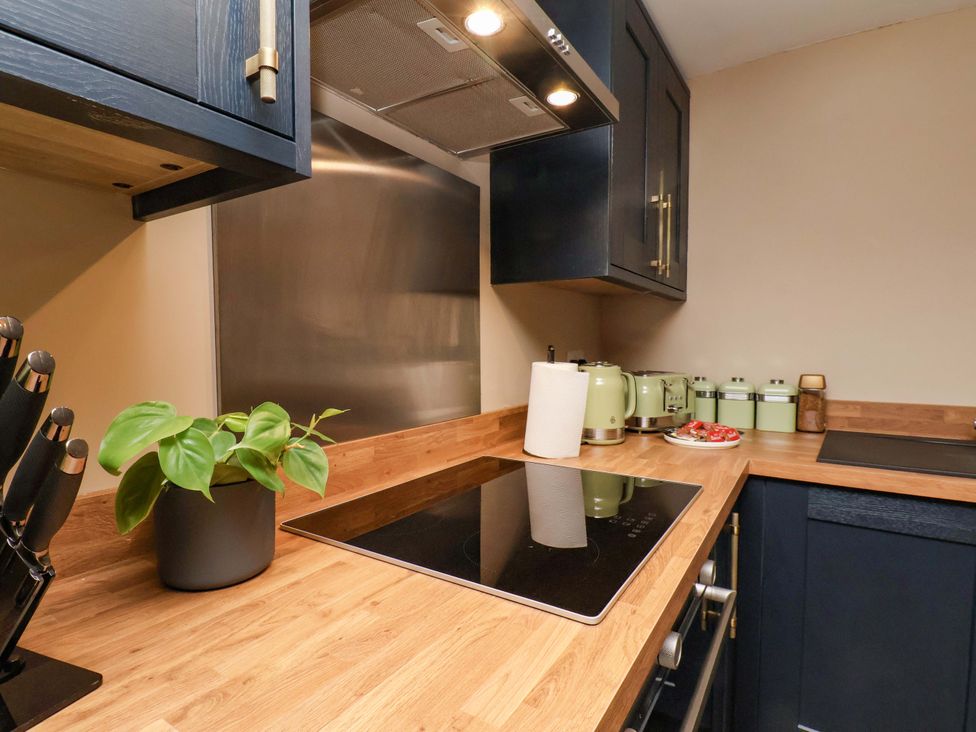 A kitchen with a cooktop and cabinets at G's Loft in Whitby