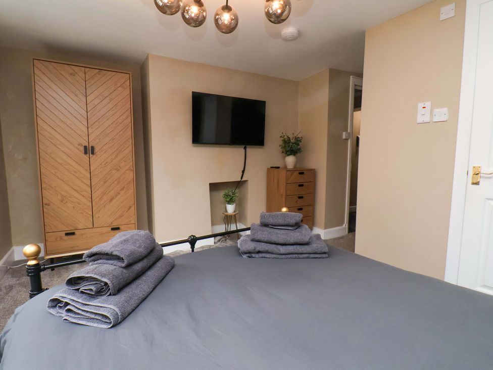 A bedroom with a bed and wardrobe at G's Loft in Whitby
