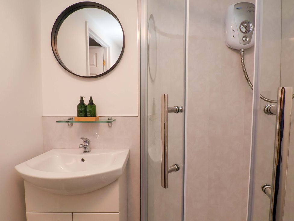 A bathroom with a shower and sink at G's Loft in Whitby