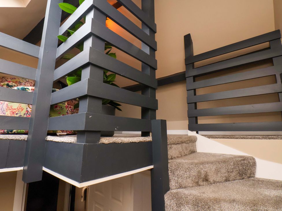 Stairs leading to a loft with railing and plant at G's Loft in Whitby