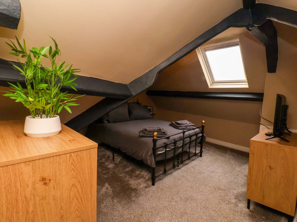 A bedroom with a bed and a plant at G's Loft in Whitby