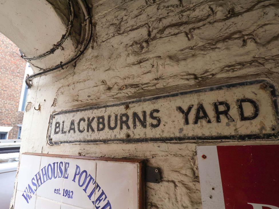 A sign that reads BLACKBURN'S YARD at G's Loft in Whitby