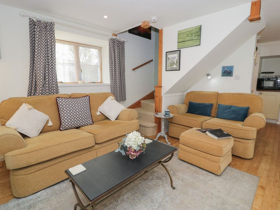 A living room with sofas and a coffee table at Happy Landing in Harlech
