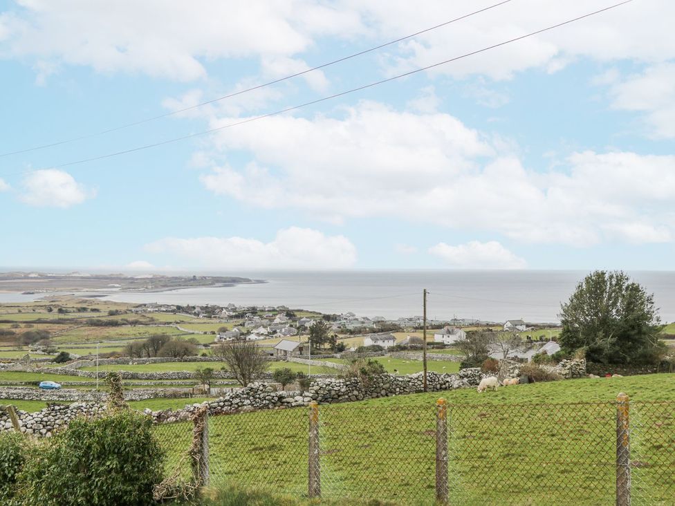 A coastal view with fields and houses at Happy Landing in Harlech