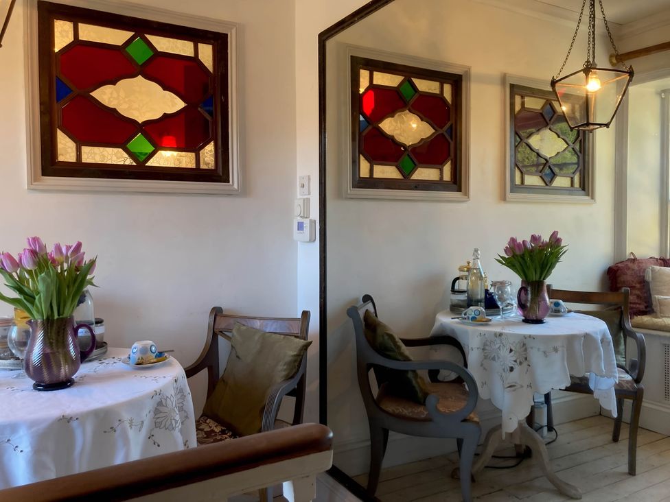 A dining room with a table and chairs at Groves Hall Garden Apartment Whitby