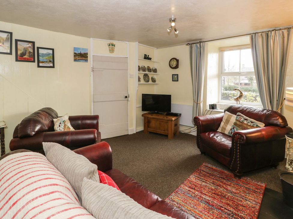 A living room with sofas and a television at Bodorwel Cottage in Penrhyndeudraeth