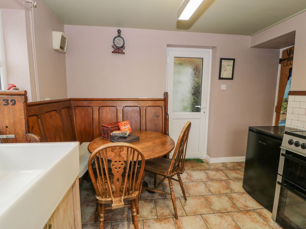 A kitchen with a table and chairs at Bodorwel Cottage in Penrhyndeudraeth