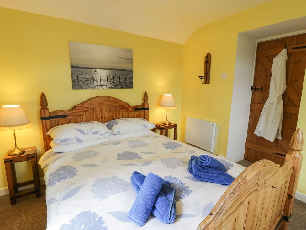 A bedroom with a double bed and nightstands at Bodorwel Cottage in Penrhyndeudraeth