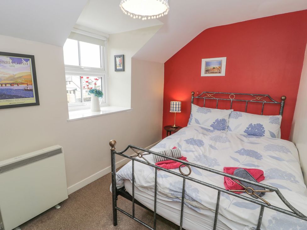 A bedroom with a bed and window at Bodorwel Cottage in Penrhyndeudraeth
