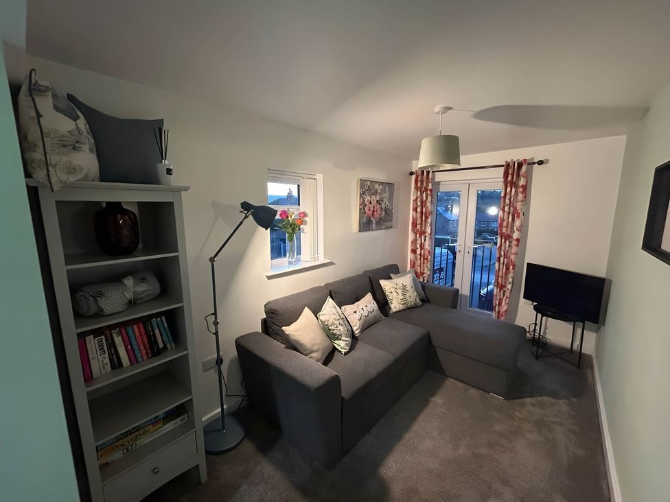 A living room with a sofa and bookshelves at 1-Bed House, Sleeps 4, Free Parking