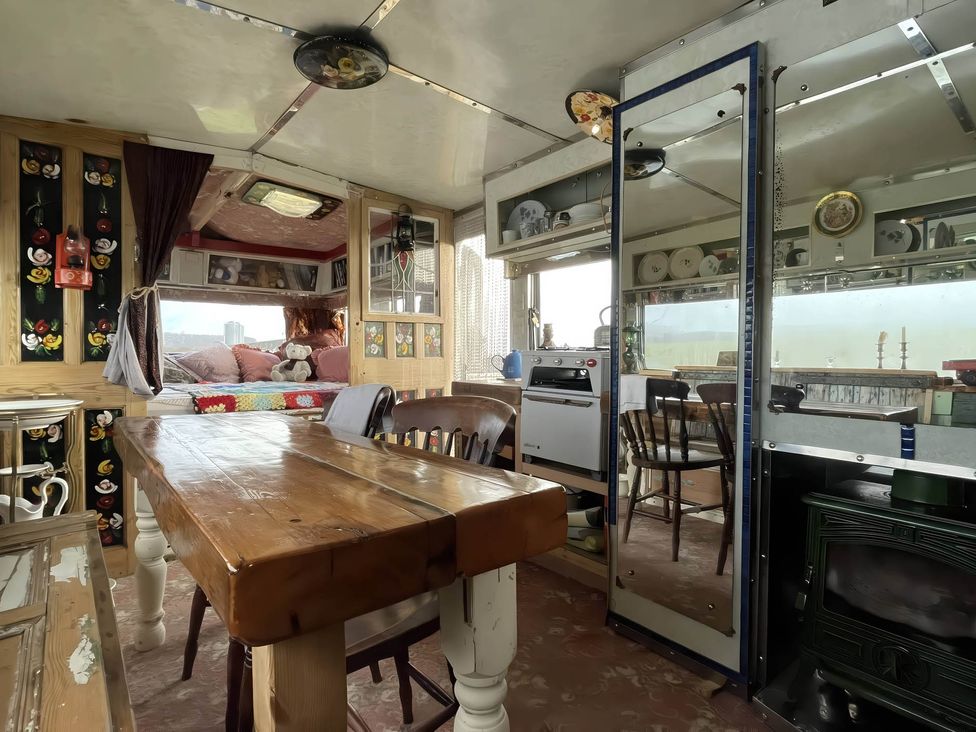 A dining area with a table and chairs at 2 x Double Bed Glamping Wagon at Dalby Forest Scarborough
