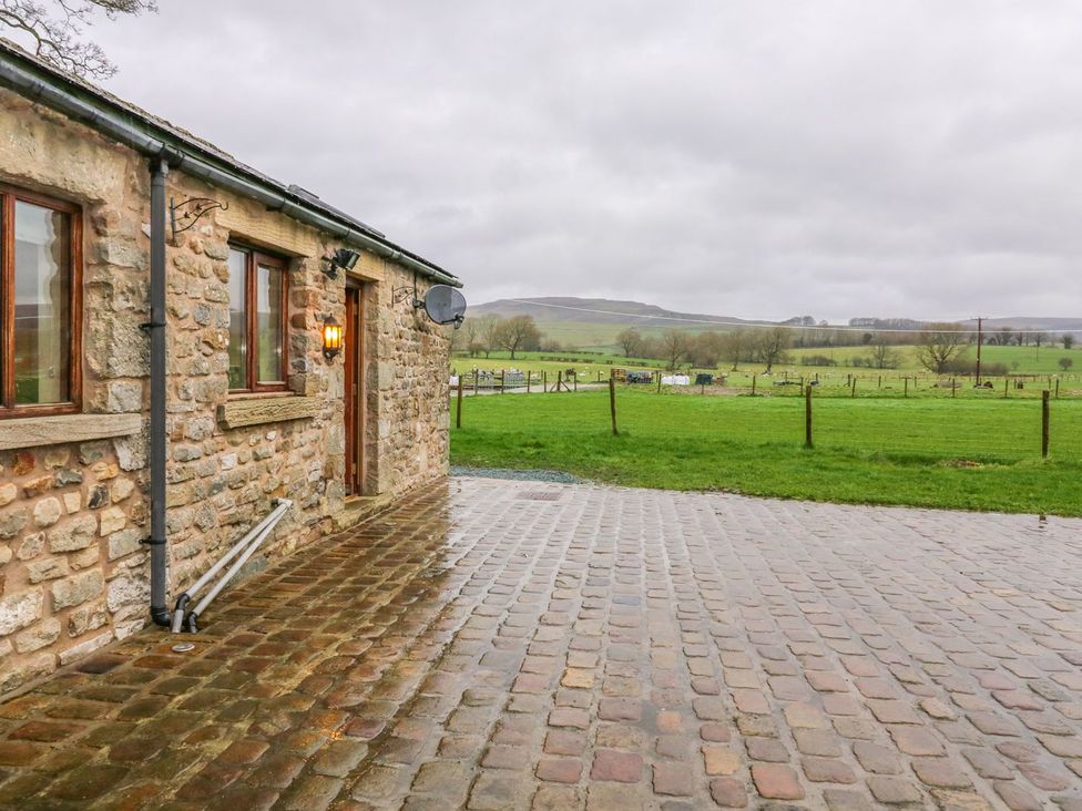 An outdoor view of a stone building with a patio at Orcaber Farm Retreat in Lancaster