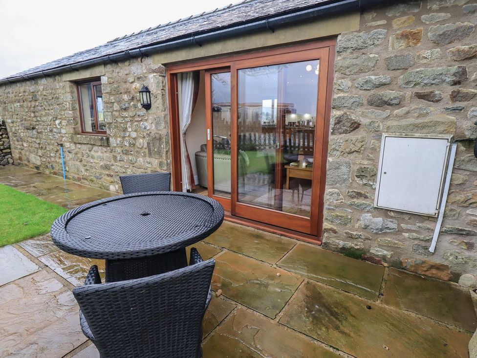 An outdoor area with a table and chairs at Orcaber Farm Retreat in Lancaster