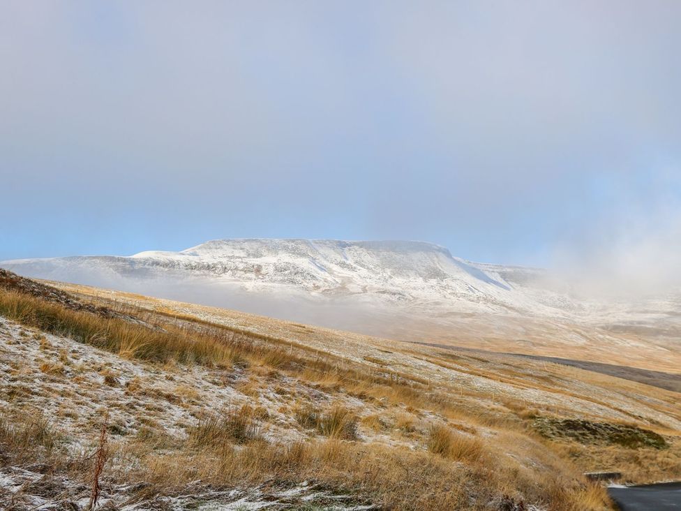 A snow-covered mountain with grassland in the foreground at Orcaber Farm Retreat Lancaster