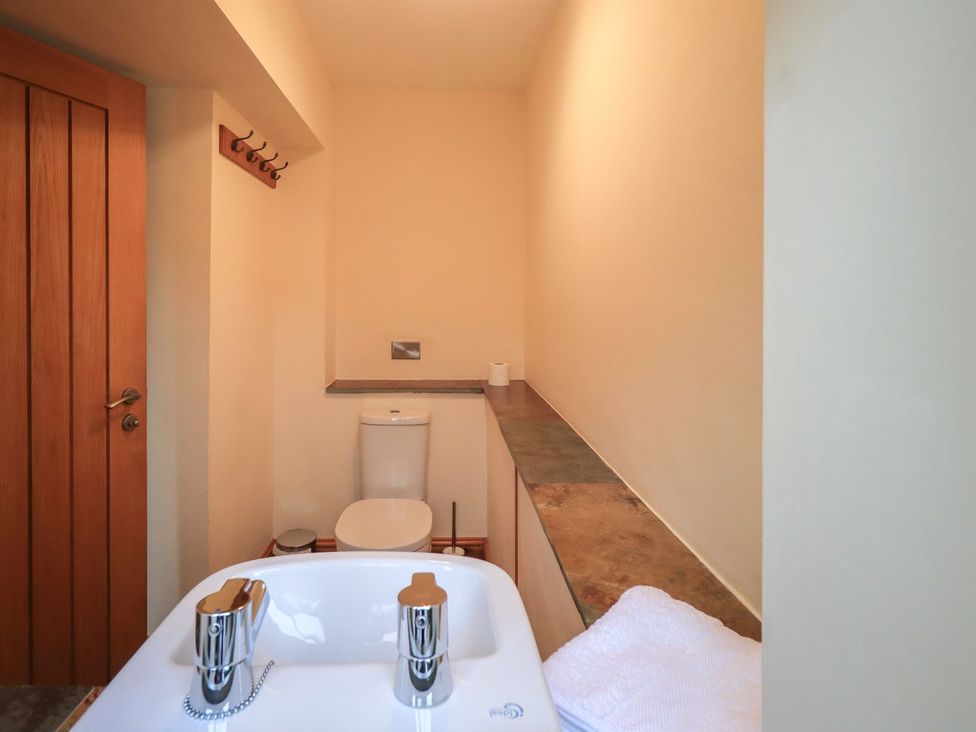 A bathroom with a sink and toilet at Orcaber Farm Barn in Lancaster
