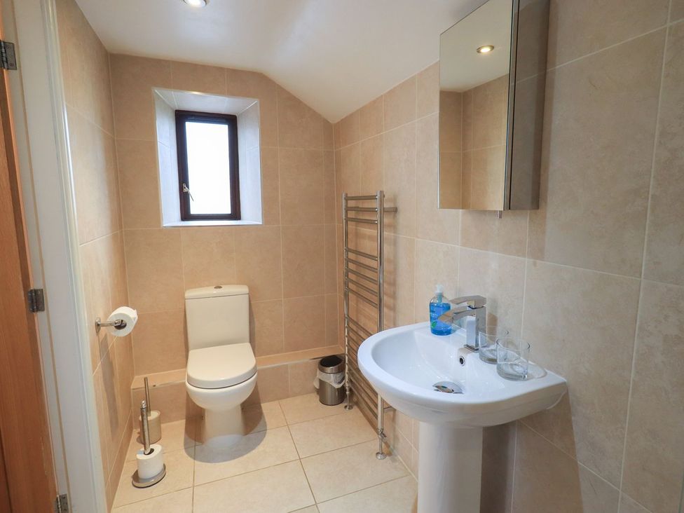 A bathroom with a toilet and sink at Orcaber Farm Barn in Lancaster