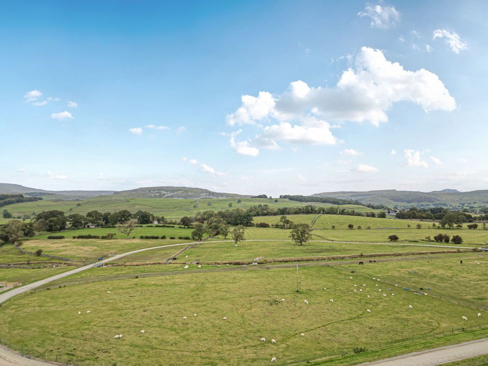 A field with sheep and a road at Orcaber Farm Barn in Lancaster