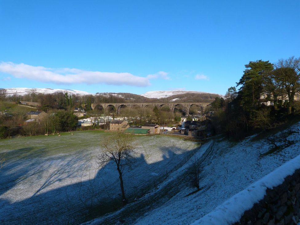 A landscape featuring a viaduct and houses at Orcaber Farm Barn in Lancaster