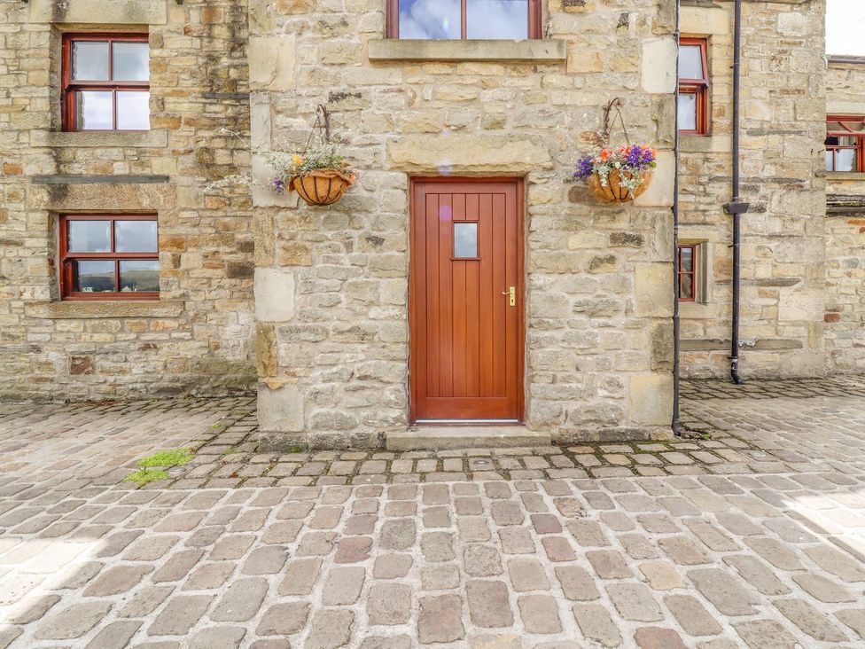 A door and windows of a stone building at Orcaber Farmhouse in Lancaster