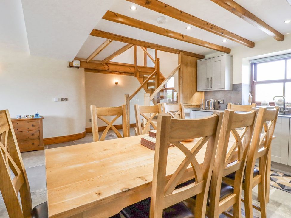 A dining room with a large table and chairs at Orcaber Farmhouse in Lancaster