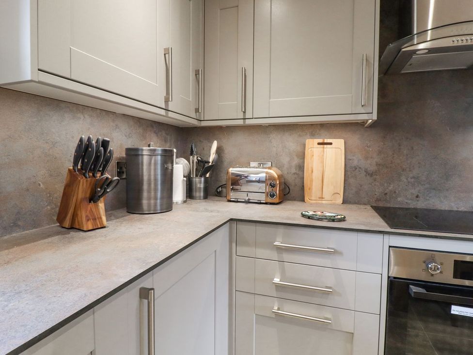 A kitchen with wooden knife block and toaster at Orcaber Farmhouse Lancaster