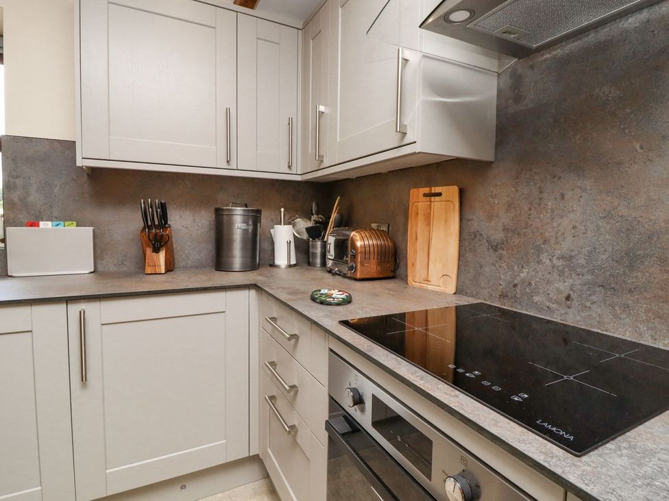 A kitchen with cabinets and appliances at Orcaber Farmhouse Lancaster