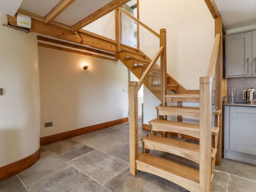 A staircase leading to upper floors at Orcaber Farmhouse in Lancaster